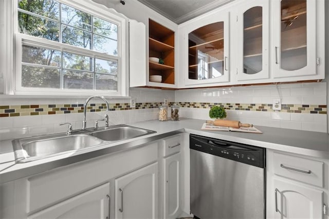 kitchen featuring backsplash, white cabinetry, sink, and stainless steel dishwasher