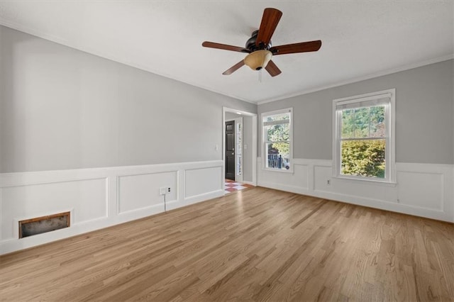 unfurnished room featuring light wood-type flooring, ceiling fan, and ornamental molding