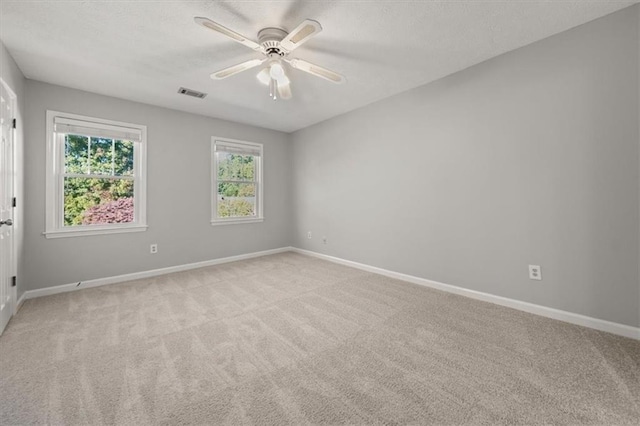 empty room featuring light carpet and ceiling fan