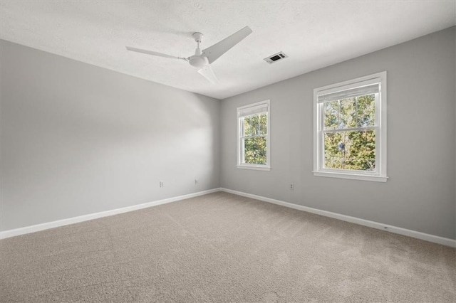 carpeted spare room with ceiling fan