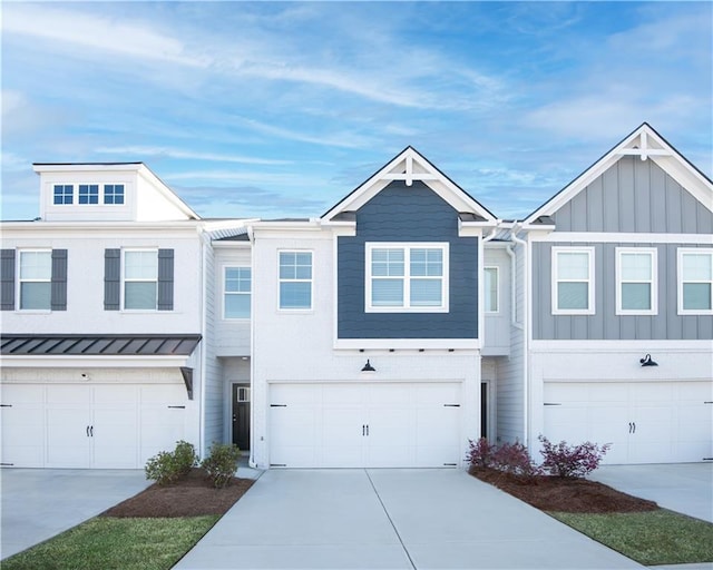 1569 Aiden Way Unit 35, Conyers, GA 30013 - townhome / multi-family property featuring board and batten siding, concrete driveway, a standing seam roof, a garage, and metal roof