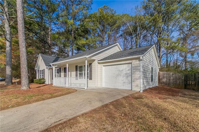 single story home with a garage, covered porch, and a front yard