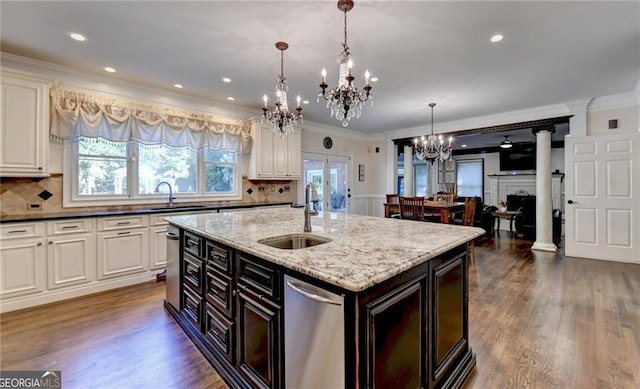 kitchen featuring a chandelier, crown molding, and a sink