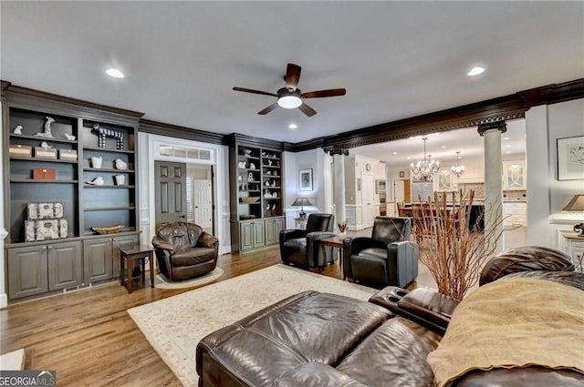 living area with light wood-style flooring, recessed lighting, ornamental molding, decorative columns, and ceiling fan with notable chandelier