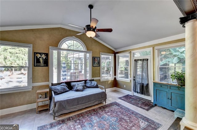 interior space with a ceiling fan, vaulted ceiling, and baseboards