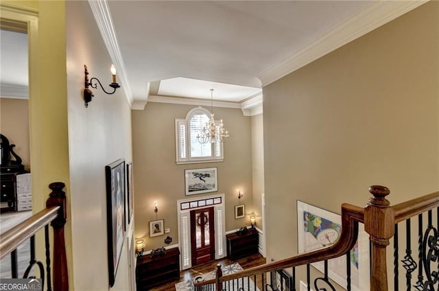 foyer entrance with crown molding, dark wood-style flooring, a chandelier, and baseboards