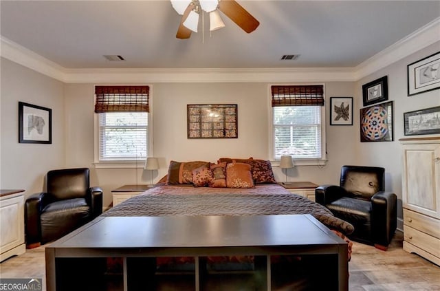 bedroom with crown molding, multiple windows, light wood-style flooring, and visible vents