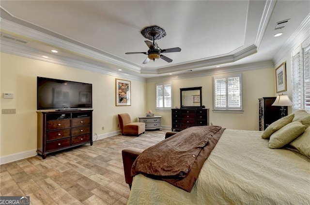 bedroom with recessed lighting, light wood-style floors, a tray ceiling, crown molding, and visible vents