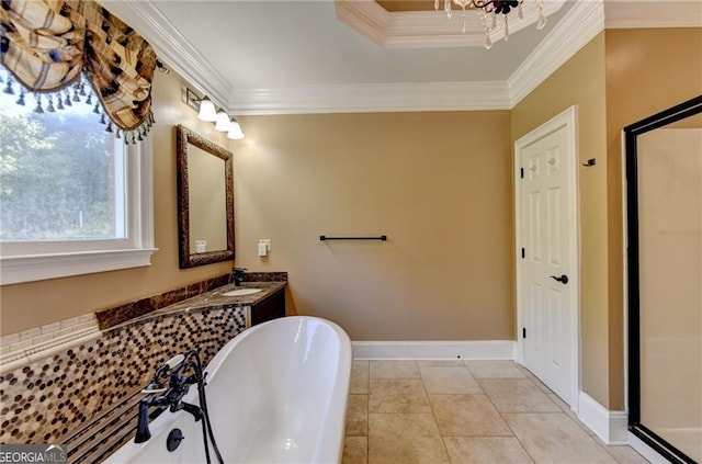 full bathroom with crown molding, a freestanding bath, vanity, and baseboards