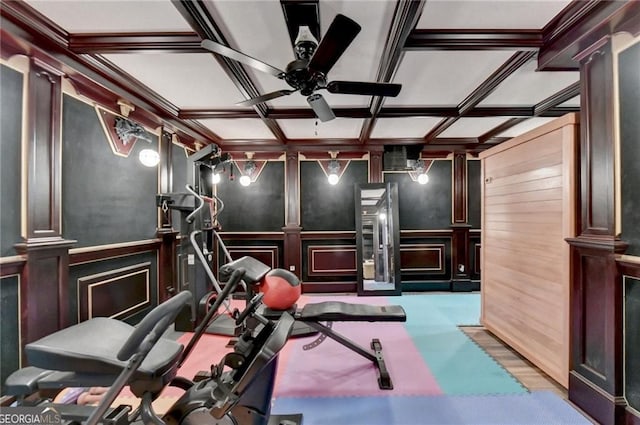 workout area featuring a ceiling fan, a decorative wall, and ornate columns