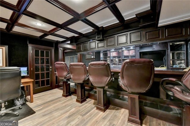 cinema room featuring beam ceiling, light wood-type flooring, and coffered ceiling