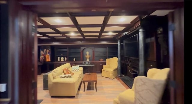 interior space with coffered ceiling and light wood finished floors