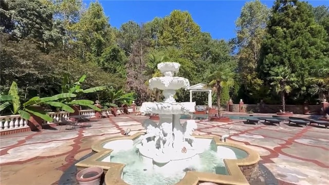 view of property's community featuring a patio and a swimming pool