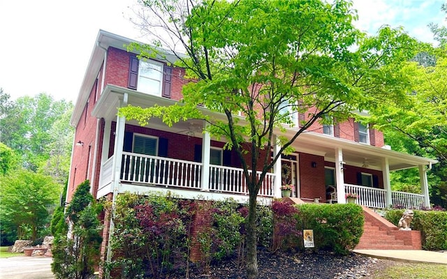 view of front of home with covered porch and brick siding