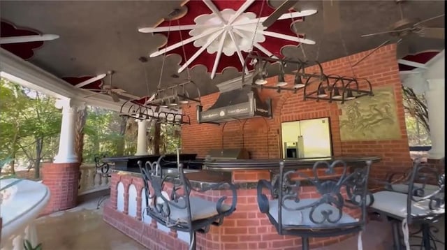 view of patio / terrace featuring ceiling fan, an outdoor kitchen, outdoor wet bar, and a grill