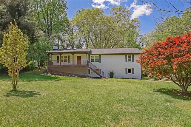 single story home featuring a porch, a chimney, and a front lawn