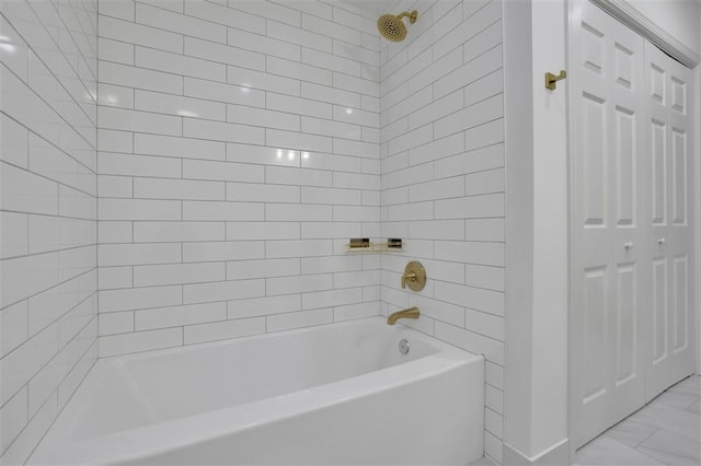 bathroom with marble finish floor and bathtub / shower combination