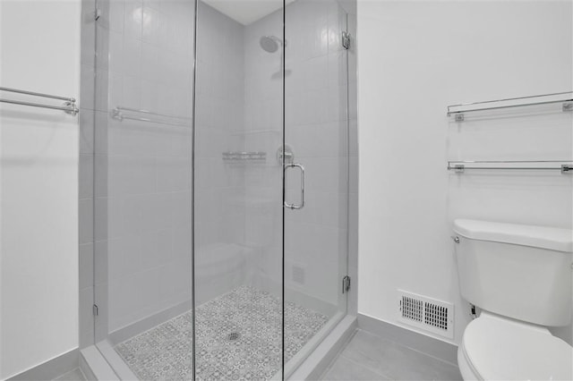 full bathroom with visible vents, baseboards, toilet, tile patterned floors, and a stall shower