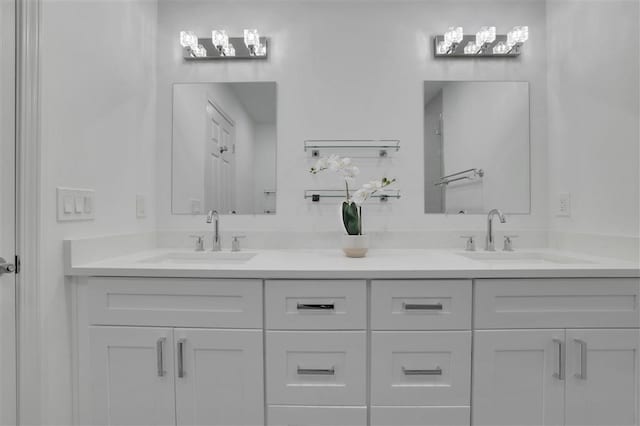 bathroom with a sink and double vanity