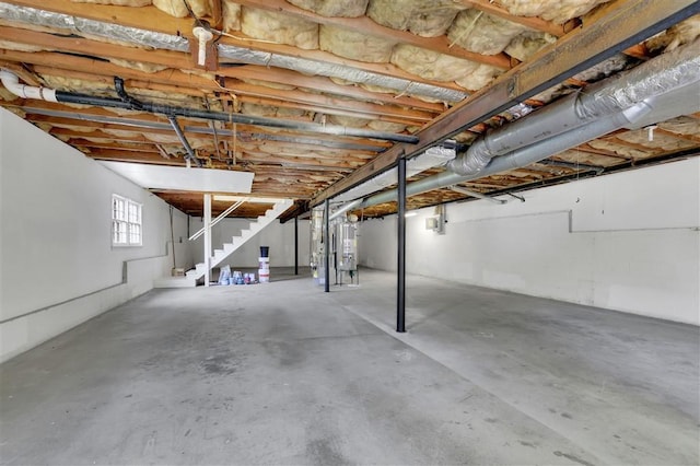 basement featuring water heater and stairway