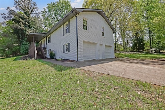 view of property exterior featuring an attached garage, a lawn, stairway, brick siding, and driveway