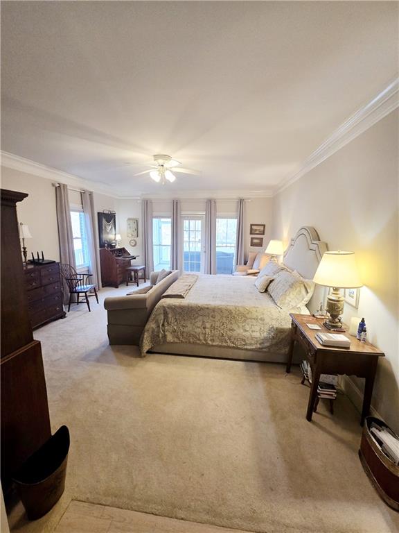 bedroom featuring ceiling fan, lofted ceiling, carpet flooring, and multiple windows