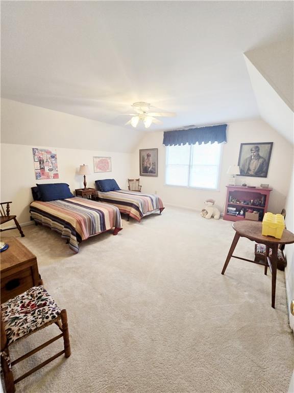 bedroom featuring vaulted ceiling, carpet, and ceiling fan