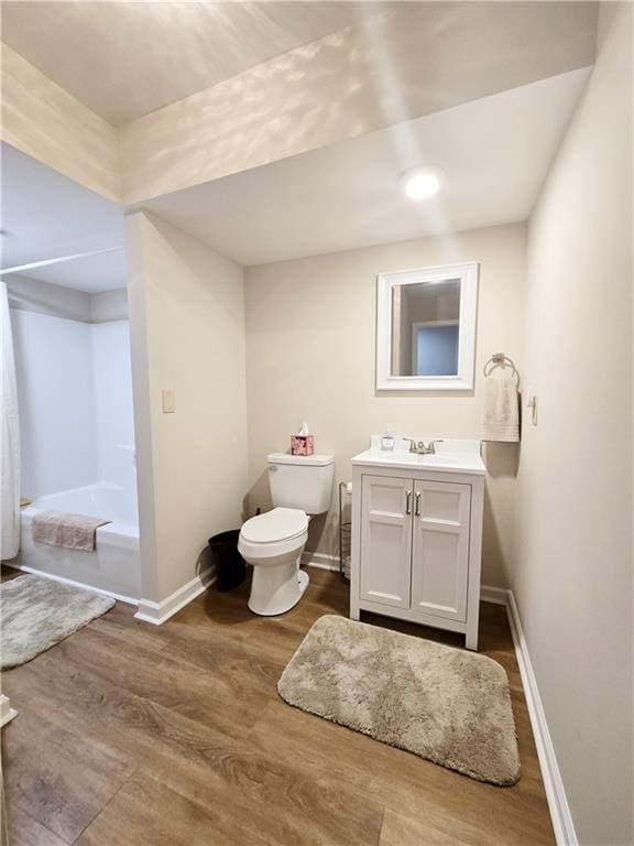 full bathroom featuring vanity, wood-type flooring, bathing tub / shower combination, and toilet