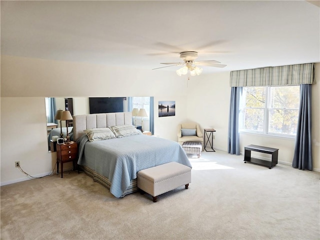 carpeted bedroom featuring baseboards and ceiling fan