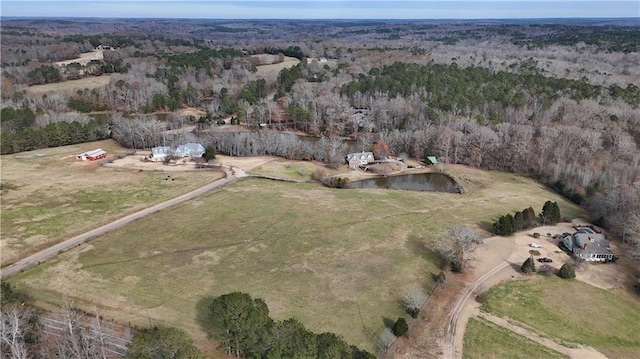 birds eye view of property featuring a wooded view