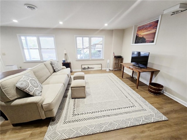 living room featuring recessed lighting, a wealth of natural light, and wood finished floors