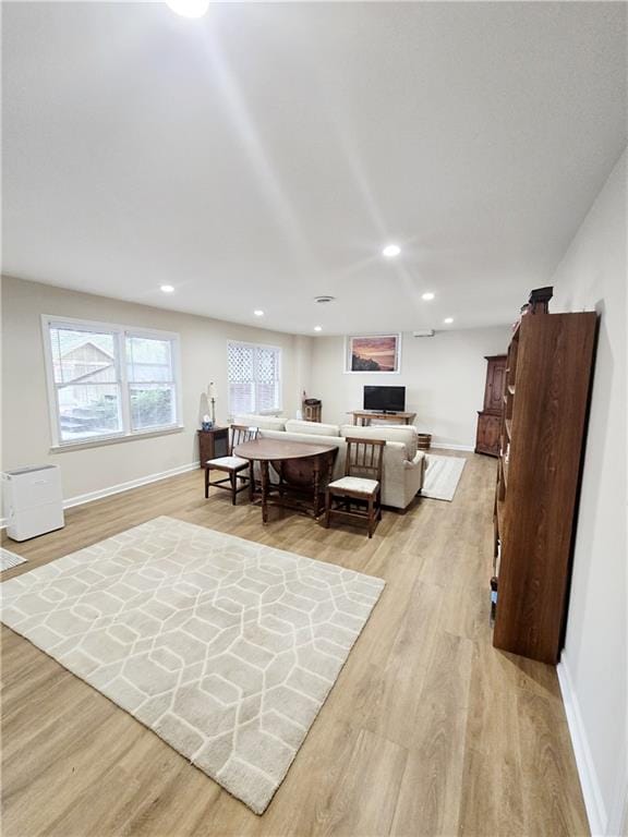 interior space featuring recessed lighting, baseboards, and light wood finished floors