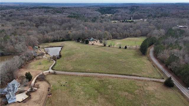 aerial view featuring a rural view, a wooded view, and a water view