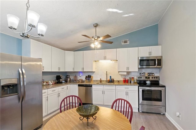 kitchen featuring visible vents, white cabinets, appliances with stainless steel finishes, and a sink