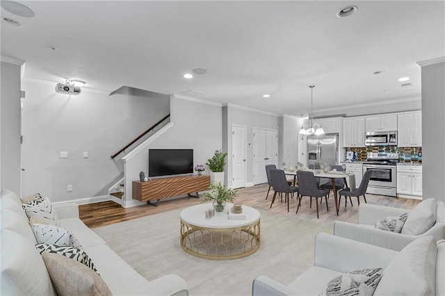 living area with baseboards, light wood-style flooring, recessed lighting, stairs, and crown molding