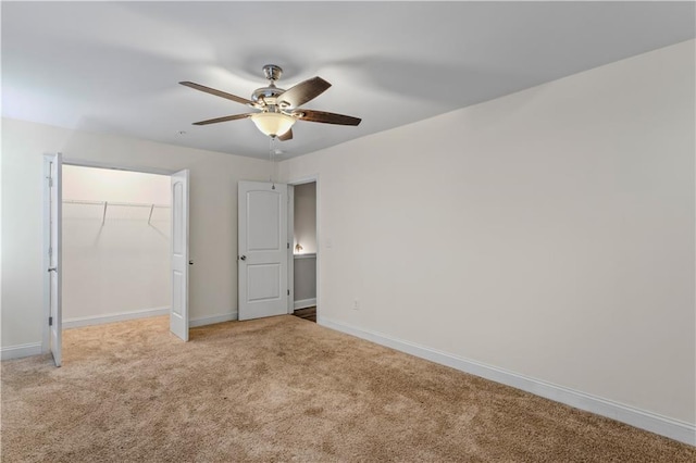 unfurnished bedroom with a closet, baseboards, ceiling fan, and carpet flooring