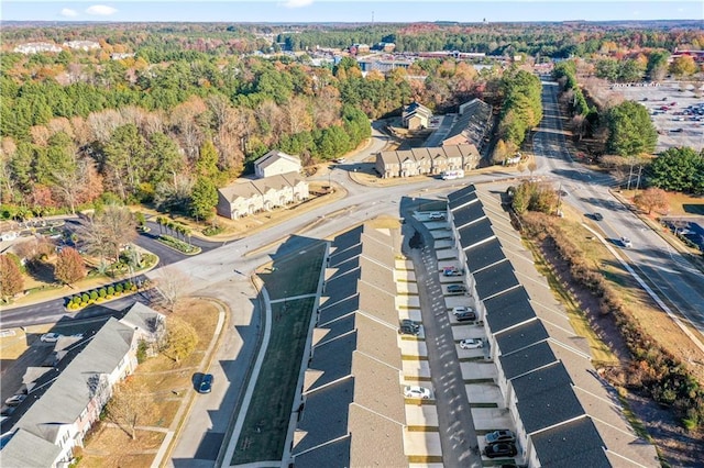 birds eye view of property featuring a wooded view