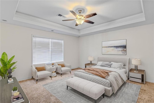 bedroom featuring visible vents, a raised ceiling, baseboards, and crown molding