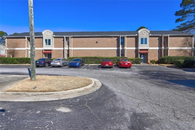 view of building exterior featuring uncovered parking