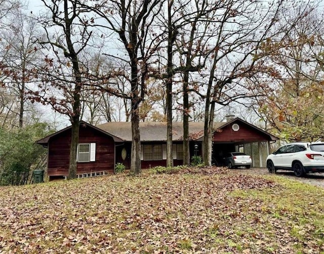 ranch-style house featuring a carport