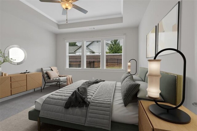 bedroom with ornamental molding, carpet, ceiling fan, and a raised ceiling