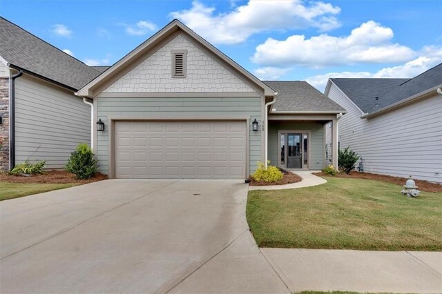 view of front of house with a front lawn and a garage