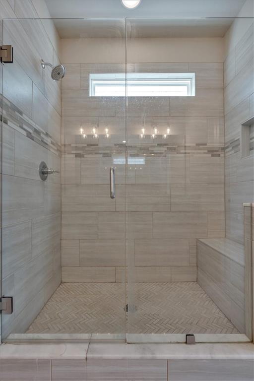 bathroom with a wealth of natural light and an enclosed shower