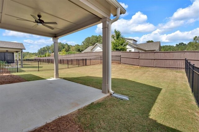 view of yard with a patio and ceiling fan