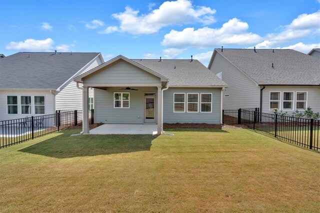 back of property featuring a lawn, ceiling fan, and a patio area