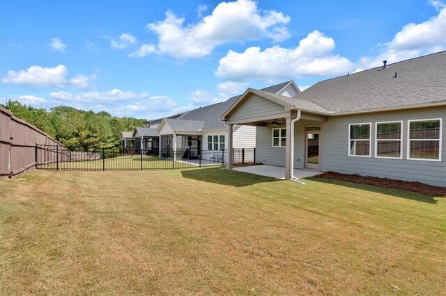 rear view of house with a lawn and a patio area