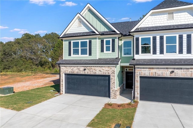 view of front of house with brick siding, board and batten siding, concrete driveway, and a garage