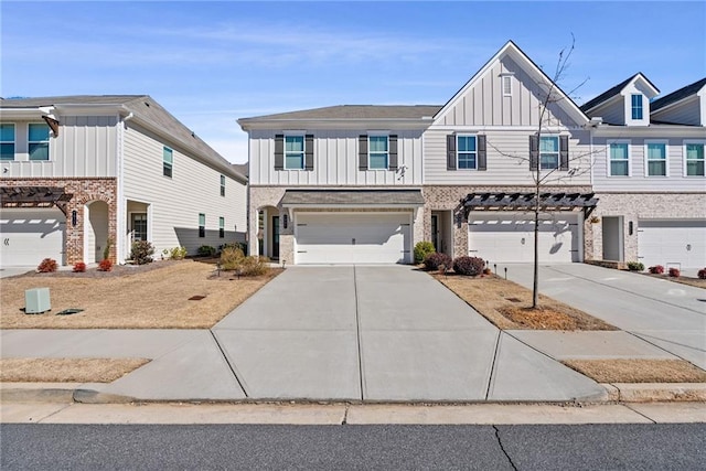 view of property featuring a garage, board and batten siding, and concrete driveway