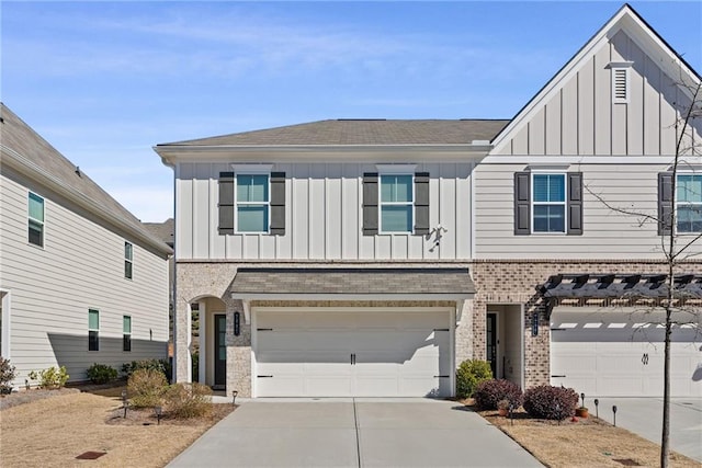 view of front of house with a garage, brick siding, concrete driveway, roof with shingles, and board and batten siding