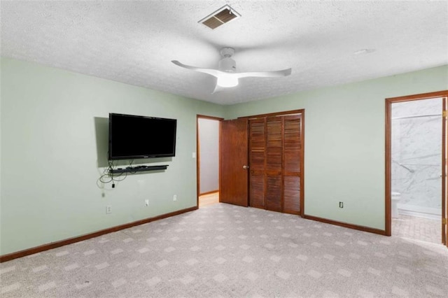 1757 Mystery Cir SW, Conyers, GA 30094 - unfurnished bedroom with a textured ceiling, a closet, carpet, baseboards, and ensuite bath